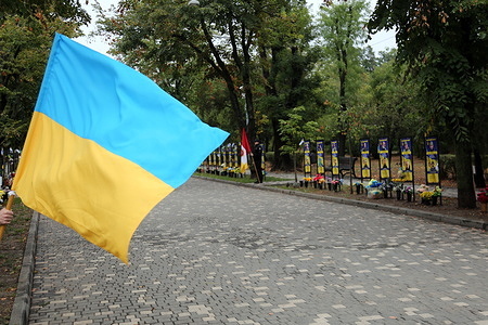 A cadet from the Institute of Internal Affairs holds the Ukrainian flag during the Defenders of Ukraine Day celebrations at the Taras Shevchenko Central Park of Culture and Recreation. On October 1, Ukraine celebrates Defenders' Day, a public holiday that coincides with the religious feast of the Protection of the Holy Virgin and Ukrainian Cossack Day. Following a change in the church calendar two years ago, its date was moved from October 14 to October 1.
On this day, Ukraine honors all those who have defended and continue to defend the country, tributes are paid to fallen defenders and thanks are given to active military personnel, veterans, participants in all Ukrainian national liberation movements, military medics and law enforcement officers, border guards and defense sector workers.