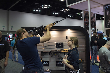 NRA members are seen checking out weapons and accessories during an exhibition.
NRA members and leaders gather in Indianapolis, Indiana for the annual NRA Meeting where President Donald Trump and others spoke and attendees were able to view a multitude of exhibits featuring firearms, outdoors equipment, and shooting gear.