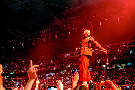 Tyler Joseph (vocals, piano, bass) of Twenty One Pilots walks above the crowd carrying an illuminated microphone. Josh Dun (drums) and Tyler Joseph (vocals, piano, bass) of Twenty One Pilots performed at AO Arena Manchester during the UK leg of The Clancy World Tour.
