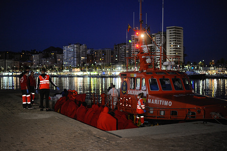 Sub saharan migrants rest on the ground after being rescued in the Mediterranean sea. Members of the Spanish Maritime Safety rescued 54 migrants near the Malaga coast and brought to Malaga Port. In this day, a total of 104 migrants were rescued in the Mediterranean sea.