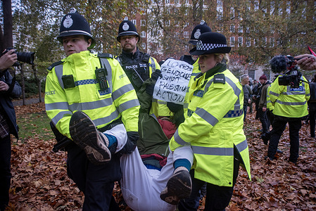 Police officers carry away an arrestee at the Tavistock Square Gardens. People gathered on the Tavistock Square, London to show their support to the Palestine Action because earlier this year it was listed as a proscribed terrorist organisation. Since, it happened supporters gather monthly to oppose the government decision.