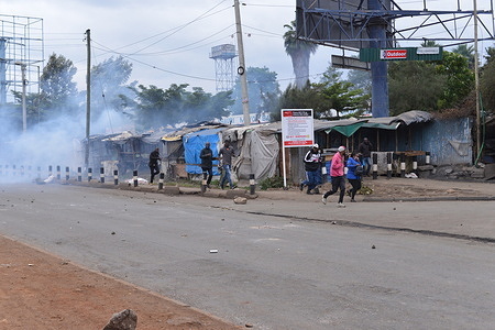 Members of the public run for safety after anti-riot police officers fired teargas canisters to disperse protesters during an anti-government protest dubbed "Saba Saba" along Jogoo Road in Nairobi.