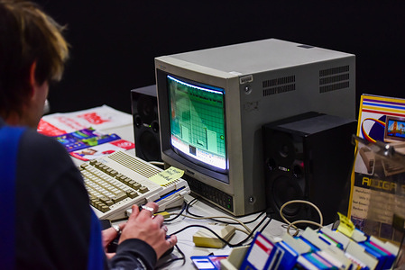 A man seen using a vintage 1992 Commodore Amiga 600, also known asan A600 home computer, connected to a vintage Sony PVM-1343MD monitor.