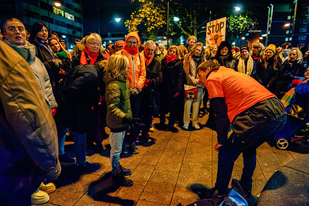 A little kid shows his support to all the women during the rally. On the International Day for the Elimination of Violence Against Women, people gathered to raise the flags for “Orange the World,” a global campaign supporting women and girls. During this United Nations initiative, buildings and landmarks in more than 100 countries are illuminated in orange, accompanied by debates, exhibitions, demonstrations, and other activities to raise awareness.