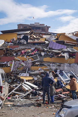 Civilians look through the rubble for items that could still be useful following the earthquake wreckage. Turkey experienced the biggest earthquake of this century in the border region with Syria. The earthquake was measured at 7.7 magnitude.