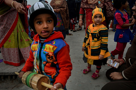 Children look at the camera as they came to celebrate Shakrain Festival in southern part of the capital Dhaka (Old Dhaka), Bangladesh.The idea behind the festival is about new crops and seeking blessing from the Hindu Goddess Laxmi, The Goddess of wealth. This Festival also Known as Pouse Songkranti.