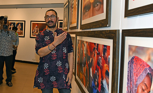 Bollywood actor Aamir Khan looks at the photos displayed at the exhibition in Maha Kumbh Mela. The photo exhibition “Mela Moments,” held during the Maha Kumbh Mela 2025 in Prayagraj, showcases award-winning photographs that capture the spiritual, cultural, and human scale of the world’s largest religious gathering. Organized by the Lalit Kala Akademi at Kumbh Gram, the exhibit presents visual narratives ranging from the rituals of Naga Sadhus to the quiet devotion of pilgrims, preserving the depth of the festival beyond fleeting moments. Running throughout the 45-day Mela, the exhibition aims to create a lasting artistic and historical record of this rare and monumental event.