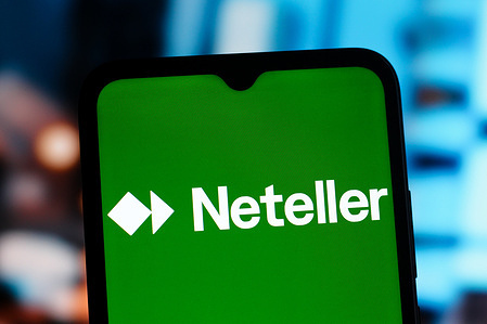 In this photo illustration, the Neteller logo is seen displayed on a smartphone screen.