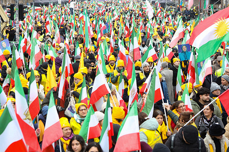 Iranian tricolor flags seen on the street as demonstrators wearing yellow scarves and vests advance during the march. Iranians and supporters of the National Council of Resistance of Iran participated in a major demonstration in Berlin on February 7 2026 in support of Iran’s nationwide uprising rejecting both monarchical and theocratic dictatorship and calling for the establishment of a democratic republic.