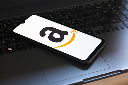 In this photo illustration, the Amazon logo is seen displayed on a smartphone screen.