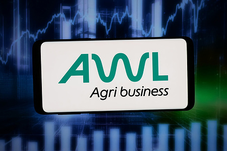 In this photo illustration, the Indian food company AWL Agri Business logo is seen displayed on a smartphone in front of abstract background on computer screen.