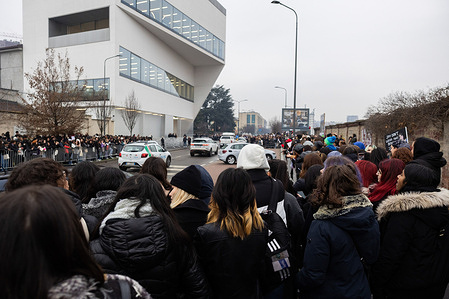 People stand outside the Fondazione Prada during the Milan Fashion Week Menswear Fall/Winter 2023/2024 in Milan.