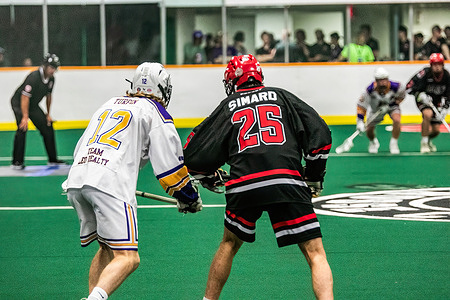 Burlington Blaze (black/orange) Alexis Simard (25) lines up with Coquitlam Adanacs (White/Yellow) Robert Turpin (12) during the Minto Cup between Burlington Blaze and Coquitlam Adanacs at Bill Hinter Arena. Final score; Burlington Blaze 10:8 Coquitlam Adanacs.