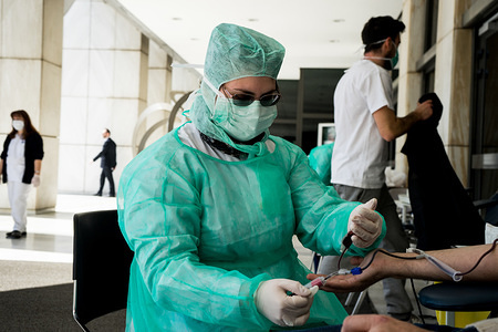 A nurse dressed in a protective suit takes blood samples from a donor during the donation process.
Due to covid-19 pandemic, intensive blood donations are organized from public health services and donation centers, to face possible blood stock reduction.