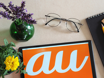 In this photo illustration, au by KDDI, a Japanese mobile phone operator logo seen displayed on a tablet.