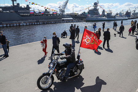 People are seen on the embankment of the Neva River while a motorcycle pass through during the Victory Day celebration.
Victory Day celebrated on May 9 in Russia, the ground part of the parade was postponed as a preventive measure against the spread of the coronavirus disease (COVID-19) pandemic