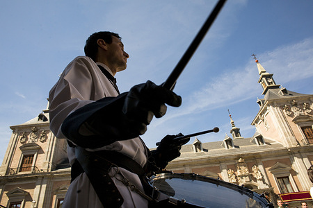 A musician and a member of the brotherhood seen walking while playing his drum during the Tamborrada in Plaza Mayor on Easter Sunday.