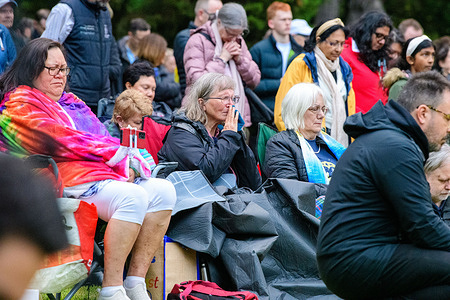 Members of the crowd bow their heads in prayer during a multi-faith Hanukkah vigil held at Caulfield Park. Community members gathered at Caulfield Park in Melbourne for an interfaith Hanukkah candle-lighting organised by Beit HaMashiach Messianic Congregation following the Bondi shooting the previous day. Victorian MP David Southwick, along with Jewish, Christian and other faith leaders, addressed the crowd and offered prayers, as organisers proceeded with the event under a visible police presence, emphasizing solidarity with the Jewish community and a commitment to continuing public celebrations despite heightened security concerns.