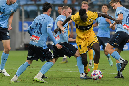 Alou Mawien Kuol (R) of Central Coast Mariners FC, Zachary Payne de Jesus (L) and Rhyan Bert Grant (C) of Sydney FC seen in action during the Isuzu UTE A-League 2024-25 season round 13 match between Sydney FC and Central Coast Mariners FC held at the Allianz Stadium. Final score Sydney FC 4:1 Central Coast Mariners.