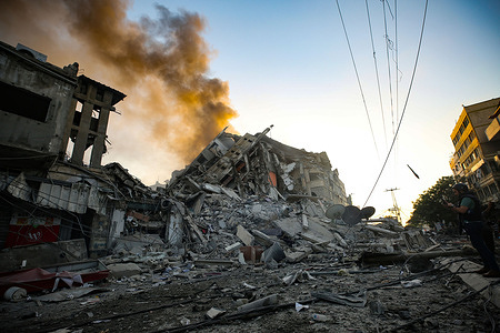 View of the debris of Al-Sharouk tower that collapsed after being hit by an Israeli air strike.