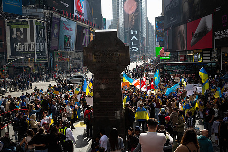 Large crowd seen from above in Times Square during the rally. Ukrainian-American protesters march from the UNICEF building to Times Square in solidarity with Ukrainian mothers and calling to save their children from Russian military aggression.