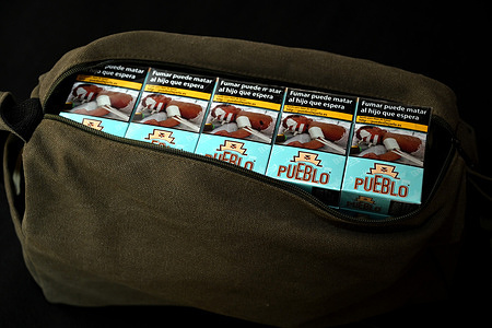 In this photo illustration, packets of Spanish cigarettes seen in a travel bag. On March 29, 2024, France had to remove by decree the limit of 200 cigarettes that a smoker was allowed to bring back from another European Union country in order to comply with European law. European regulations set personal consumption at 800 cigarettes (4 cartons), or 400 cigarillos, or 200 cigars and or 1 kilogram of smoking tobacco.