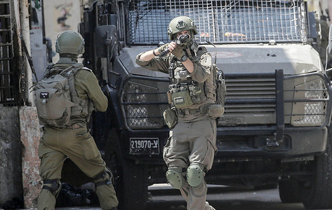 An Israeli soldier takes position during an Israeli military operation inside the Balata refugee camp in the West Bank city of Nablus. The Israeli army launched a large-scale arrest campaign, raiding and ransacking Palestinian homes. During the operation, several Palestinians were detained, and residents were forced to evacuate. Notably, many of these evacuated Palestinian homes were seized and converted by Israeli forces into military barracks.