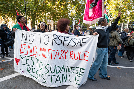Young protesters hold a banner reading "No to RSF/SAF, end military rule" during the rally. Demonstrators marched in London to show solidarity with the people of Sudan and call for an end to UK arms sales to the UAE, which campaigners say enable atrocities by the RSF militia across the country.