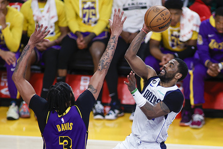 Dallas Mavericks guard Kyrie Irving (R) shoots against Los Angeles Lakers forward Anthony Davis (L) during an NBA basketball game at Crypto.com Arena in Los Angeles.