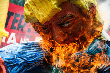 Donald Trump effigy is seen burning along Kalaw Avenue during a protest holds by indigenous people from Mindanao. Comprising mostly of indigenous people from Mindanao, (the second biggest Philippines island) hundreds protesters marched towards the U.S. embassy to protest against the political ideas of the US president Donald Trump and the Philippines president Rodrigo Duterte in Roxas Boulevard before being blocked by the crowd control police officers in Kalaw Avenue, a few hundred meters away from the U.S. embassy.