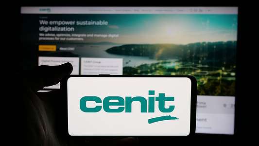In this photo illustration, a cellphone with the logo of German information technology company CENIT AG is seen on screen in front of business webpage.