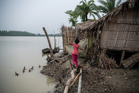 Houses are seen partially damaged after a heavy storm in a coastal area at Kalabogi in Khulna. Not too long ago Kalabogi, a coastal village in Bangladesh, was full of cultivable land until rising sea levels began to swallow the area all the way up to the Bay of Bengal. Frequent cyclones and floods have hit the village since the late 1990s. In 2009, a major cyclone named Aila destroyed the country's 1,400 kilometres of embankments, 8,800 kilometres of roads, and about 3,50,000 acres of farmland. Several hundred people were reportedly killed in the disaster. The farmers of Kalabogi were the worst hit. As most of the village land was submerged, the people of Kalabogi built new homes on bamboo poles 4 to 5 feet above the ground.
