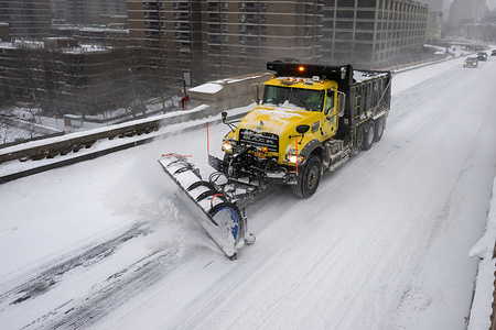 New York City Department Of Transportation (DOT) snow plows clears snow on the Brooklyn Bridge as a massive snow storm sweeps across the United States on January 25, 2026 in New York City.