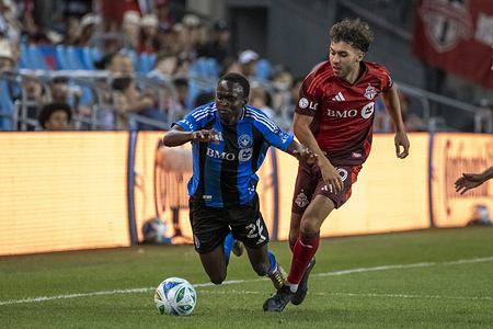 #22 Victor Loturi (L) and #19 Kobe Franklin (R) in action during the MLS game between Toronto FC and FC Montreal at BMO field. Final score; Toronto FC 1:1 FC Montreal