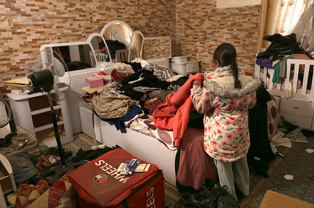 Palestinian girl Sarah Hasiba makes her bed inside her home after the Israeli forces arrested her father, Rami Hasiba, and her brother, Muhammad, from their home in Nablus in the West Bank. Israeli forces raided the house, threw an explosive device inside, and ransacked its contents.