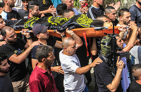 (EDITOR'S NOTE: Image depicts death)Mourners carry the flag-draped body of 18-year-old Abdullah Abu Hassan, a local fighter from the Al-Quds Brigades armed wing, killed earlier in the clashes with Israeli troops when they raided the village of Kafr Dan in the northern West Bank, during his funeral procession in the village of Alyamon west of Jenin. At least 239 Palestinians, 32 Israelis and two foreigners have been killed so far this year in the Israeli-Palestinian conflict.