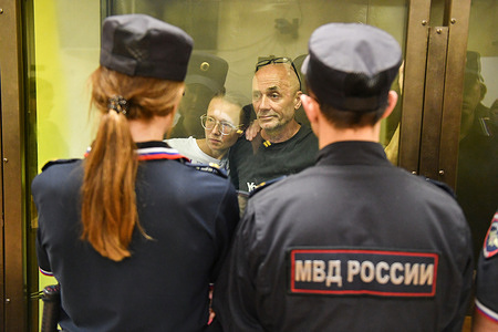Defendants Alexander Dotsenko and Anastasia Dyudyayeva, accused of incitement to terrorism, listen to the verdict in the courtroom during their trial for leaving anti-war notes in a supermarket. The military court in St. Petersburg sentenced artist couple Alexander Dotsenko and Anastasia Dyudyayeva to imprisonment. Dotsenko received a 3-year sentence in a penal colony, while Dyudyayeva was sentenced to 3.5 years. They were found guilty of incitement to terrorism for distributing leaflets with anti-war slogans and calls for violence against Russian President Vladimir Putin in the "Lenta" hypermarket.
