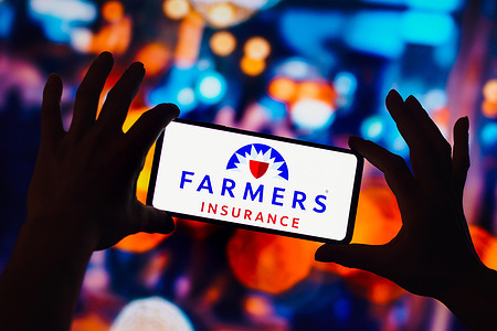 In this photo illustration, the Farmers Insurance Group logo is seen displayed on a smartphone.