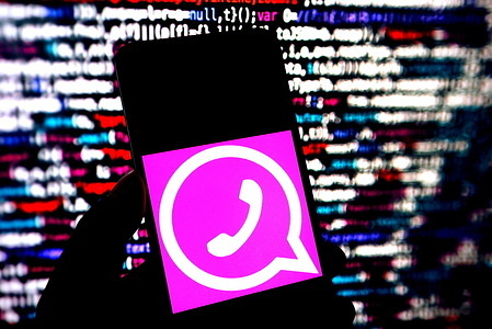 In this photo illustration, a Pink Whatsapp logo is seen displayed on a smartphone.