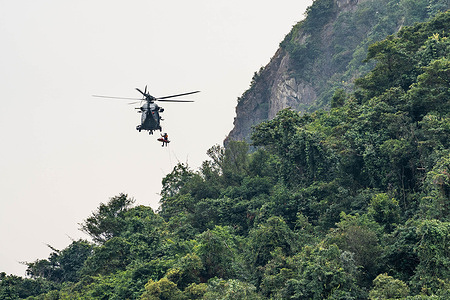 A Hong Kong Government Flying Service Airbus H175 helicopter (Registration: B-LVG) seen during a recue mission to provide medical assistant to an injured rock climber who has fallen off the cliff at Central Crag.