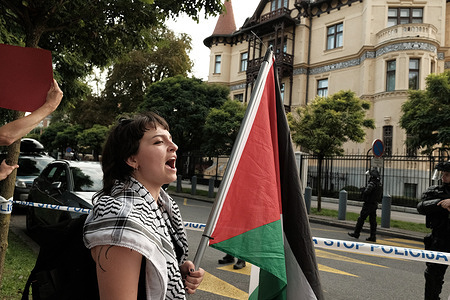 A protester shouts in front of a police protected American Embassy at a protest for Gaza. Aimed at drawing attention to the starvation of Palestinians and demanding a complete halt to the cooperation with Israel, the protest follows the country ’s decision to impose an arms ban on Israel and ban imports from illegal Israeli settlements.