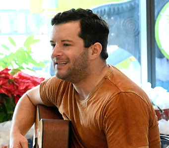 Country singer Daniel Harrison sings to the parents and patients at the Annual Christmas Show And Gift Giving At Shriner's Children's Hospital.