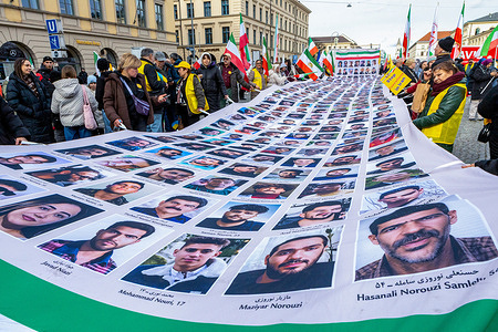 Demonstrators hold a large banner displaying photographs and names of victims during the rally at Odeonsplatzon. As world leaders met at the Munich Security Conference, Iranian expatriates and supporters of the National Council of Resistance of Iran rallied at Odeonsplatz, rejecting both religious dictatorship and monarchy, urging international leaders to support the Iranian people’s struggle and hold Tehran accountable.