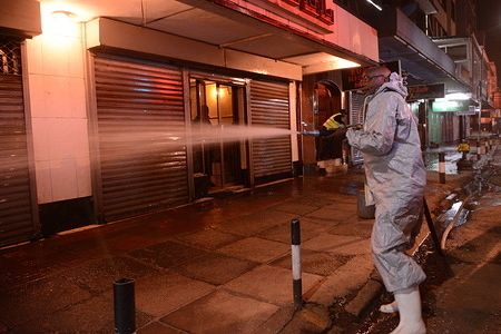 A firefighter dressed in a protective suit fumigates stalls and shops using a fire engine motor vehicle during day one of the dusk to dawn countrywide curfew that was imposed by President Uhuru Kenyatta as a preventive measure against the spread of coronavirus. 
Kenya has so far recorded only 31 cases and 1 death of covid-19.