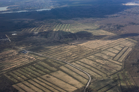 View from an airplane window showing endless stretches of forest somewhere between the Murmansk region and the Republic of Karelia during a flight from Murmansk to St. Petersburg.