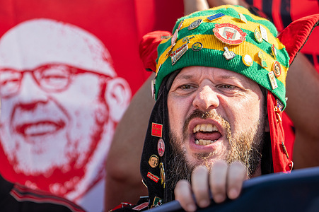 A Manchester United fan reacts during the protest. Hundreds of Manchester United supporters gathered on Sir Matt Busby Way outside Old Trafford stadium to launch an angry protest against the club's ownership. The demonstration, organised amid growing fury over fan treatment and skyrocketing season ticket prices, saw crowds ignite red and green smoke flares and hoist fierce banners targeting both the Glazer family and co-owner Sir Jim Ratcliffe.