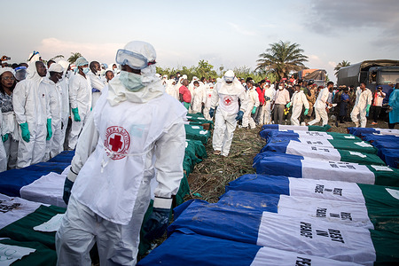 Coffins are lined up ahead of a mass burial for victims of the fuel tanker explosion, which took place on November 5, 2021. At least 107 people were killed after a turning fuel tanker was hit at speed by a truck and the leaking fuel caught fire. The victims included women traders, motorbike drivers who rushed to collect the fuel, and passengers in minibuses.