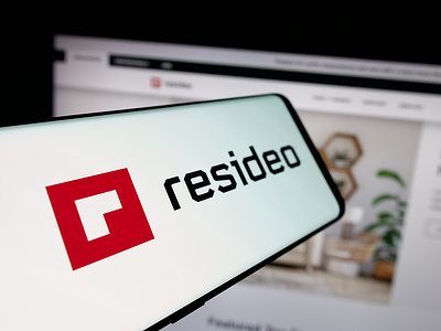 In this photo illustration, a smartphone with the logo of US security company Resideo Technologies Inc. is seen on screen in front of website.