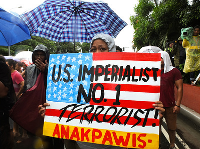 A female member of Anak Pawis militant group holding a big placard.
While the Philippines celebrated it's 120th Independence Day, militant groups staged a protest at the US Embassy, slaming President Rodrigo Duterte's Policies and programs. They said that would only benefit US, China and other foreign corporations.