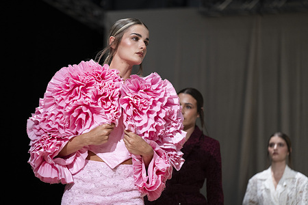 A model walks the runway wearing a design by Romanian designers during Momad Fashion Week de Madrid in IFEMA